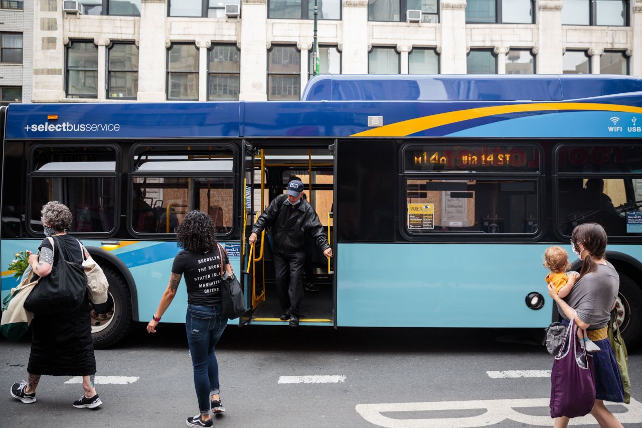 A commuter exits from a bus at a stop in New York on June 3.