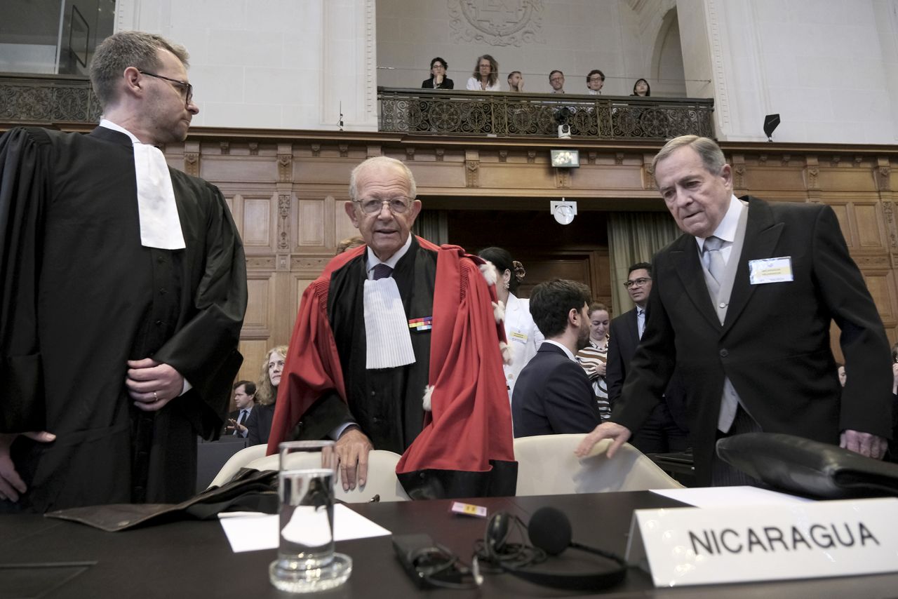 Nicaragua's Ambassador Carlos Jose Arguello Gomez, right, and Alain Pellet, center, a lawyer representing Nicaragua, arrive for the start of a two days hearing at the World Court in The Hague, Netherlands, on April 8.
