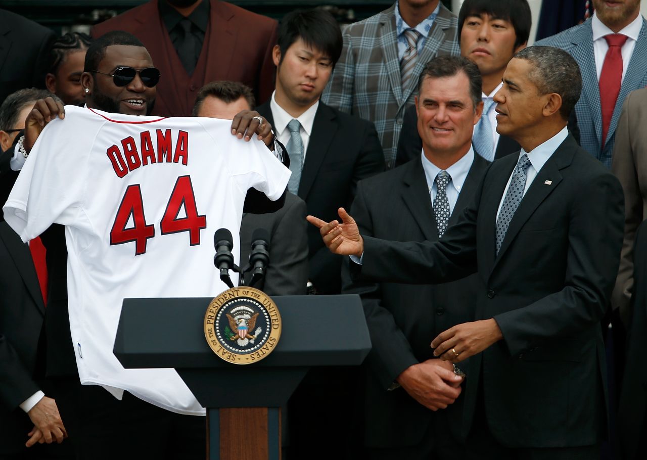 In this file photo, former Boston Red Sox designated hitter David Ortiz holds a Red Sox jersey presented to former US President Barack Obama during a ceremony at the White House on April 1, 2014 in Washington, DC.  