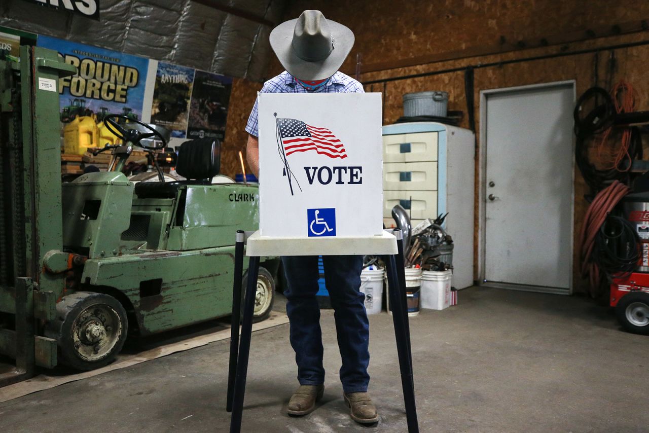 A voter marks his ballot at a polling place in Dennis Wilkening's shed on November 3, in Richland, Iowa. 
