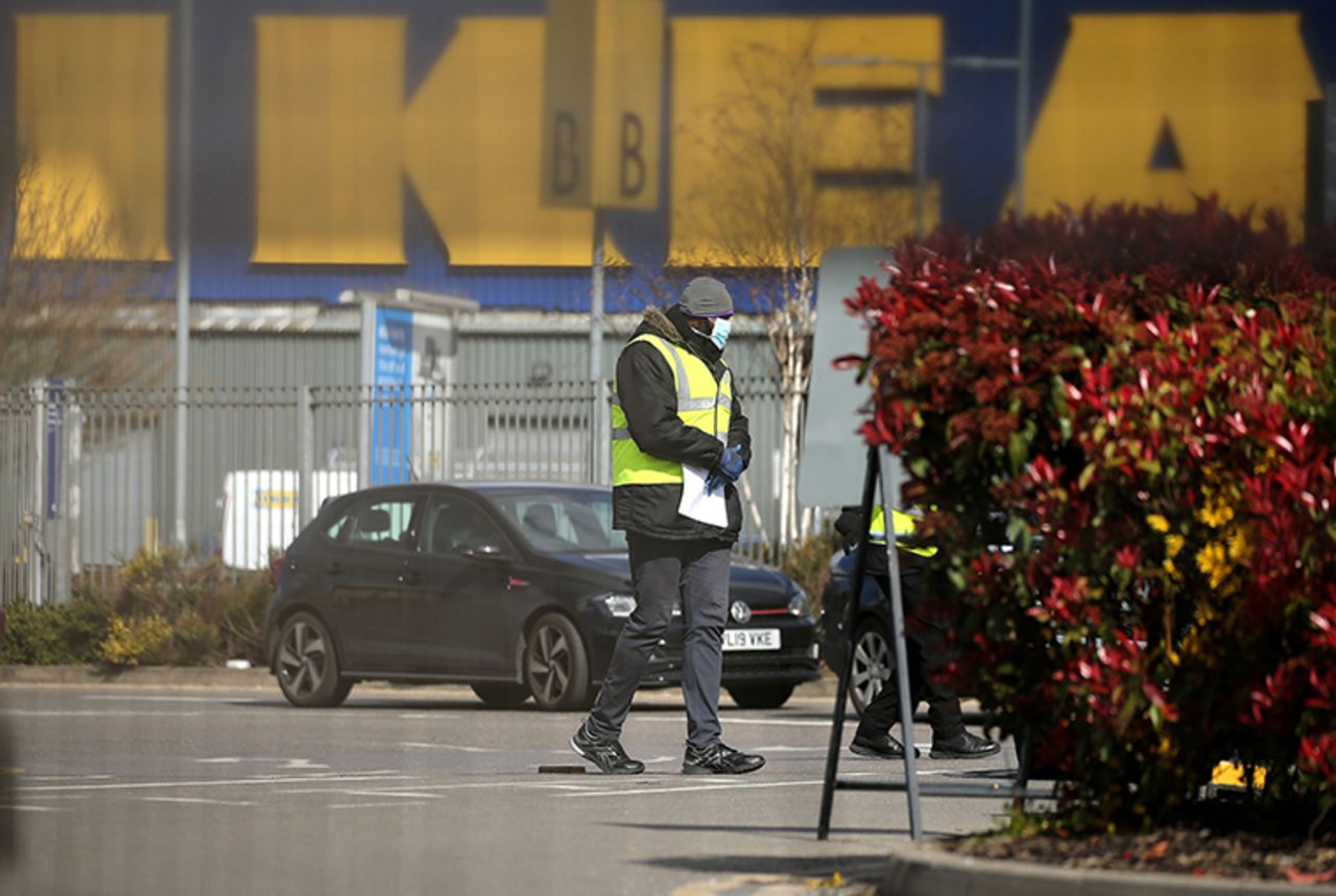 Britain's NHS workers wait in their cars to be tested for COVID-19 at a drive-in facility set up in the car park of an IKEA store in Wembley, north-west London on Tuesday, March 31. 