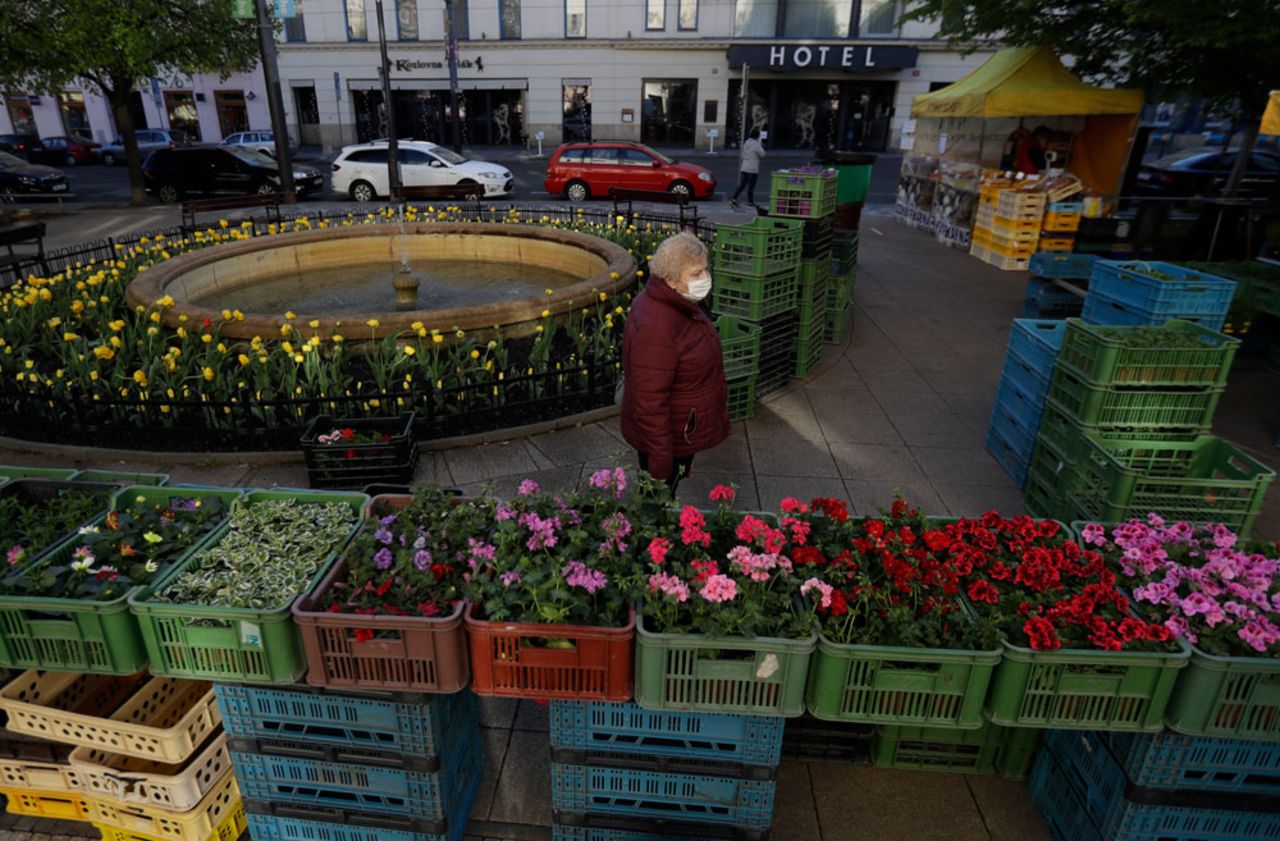 A woman shops at the recently-opened farmers' market in Prague on Monday, April 20. 