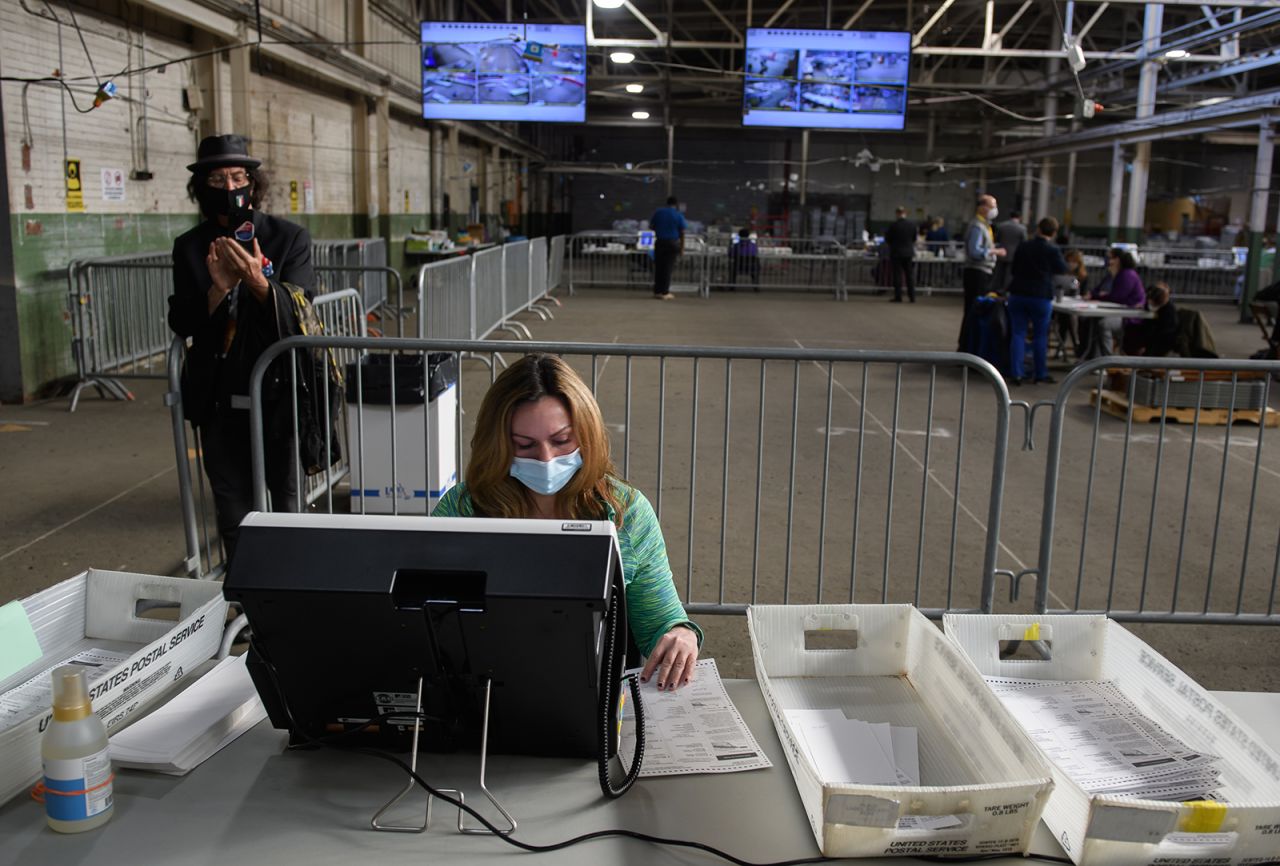 A Trump campaign poll watcher films the counting of ballots at the Allegheny County elections warehouse on November 6, in Pittsburgh, Pennsylvania. 