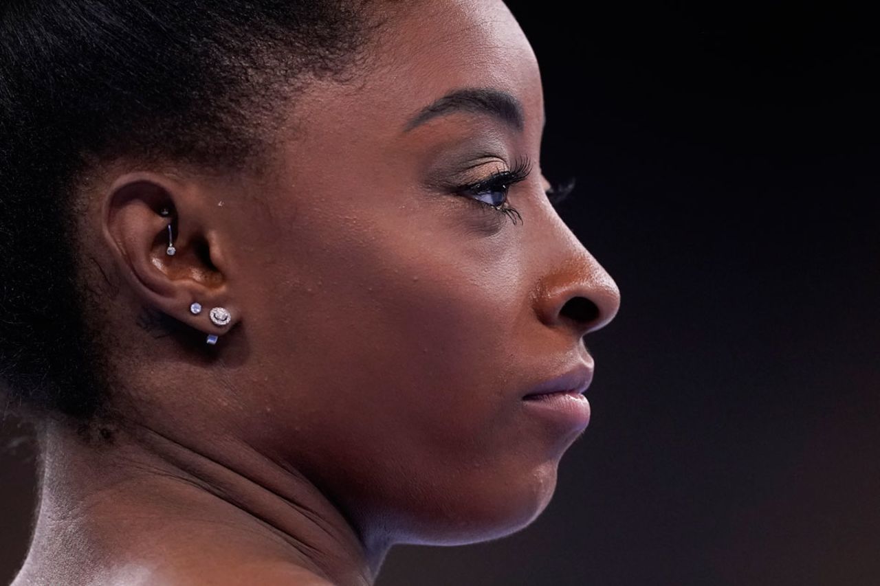 Simone Biles stand on the mat during the warm up prior to the artistic gymnastics balance beam final.