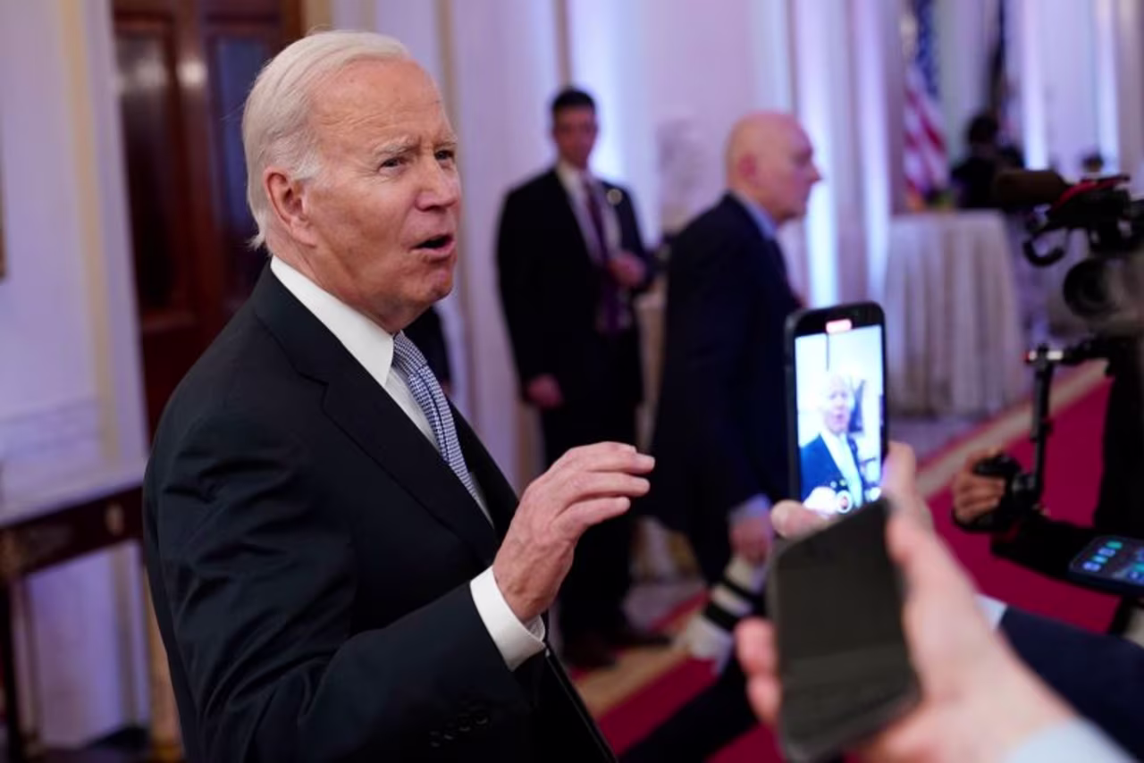 President Joe Biden talks with reporters after speaking in the East Room of the White House on Friday. 