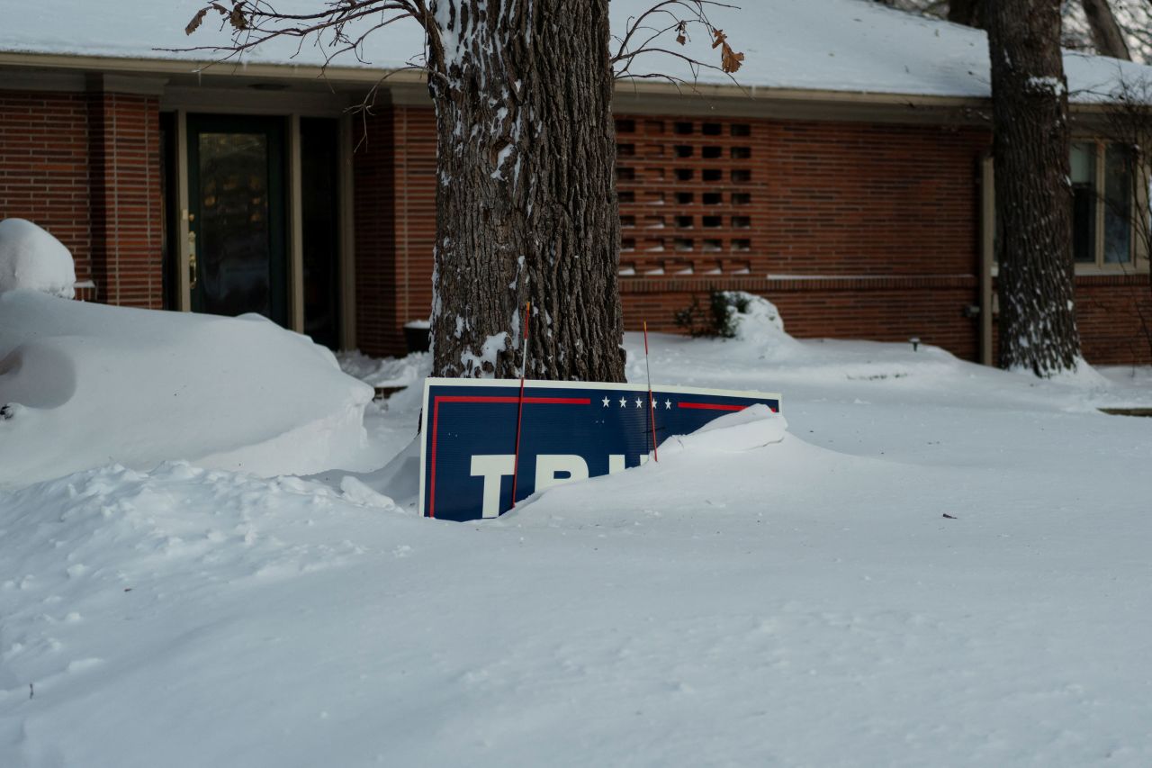 A campaign yard sign is just barely visible above snow in Des Moines, Iowa, on Sunday.