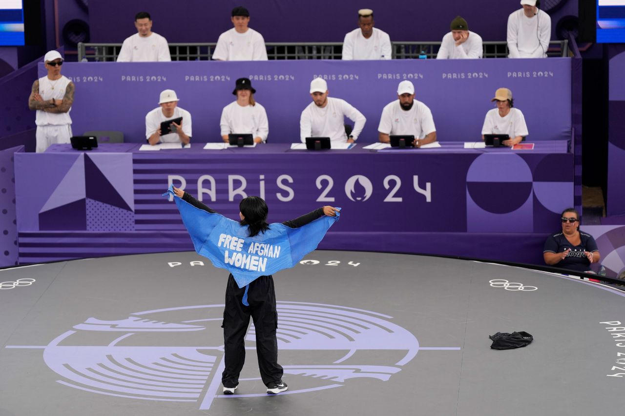 Talash shows a cape that says "Free Afghan Women" on it as she competes on Friday.