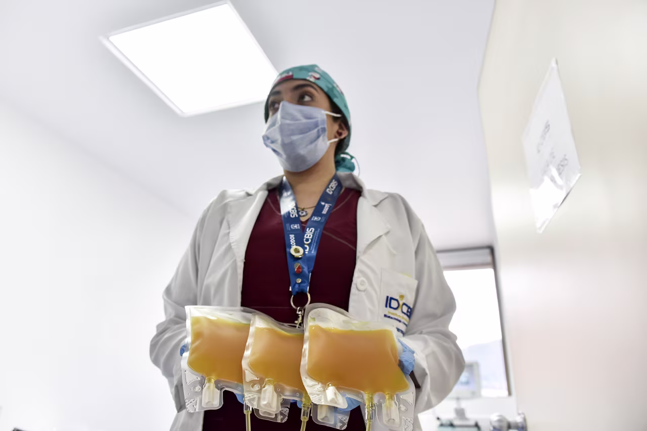 Nurse Lina Acevedo holds the plasma donated by a man who recovered from COVID-19 on August 14 in Bogota, Colombia.