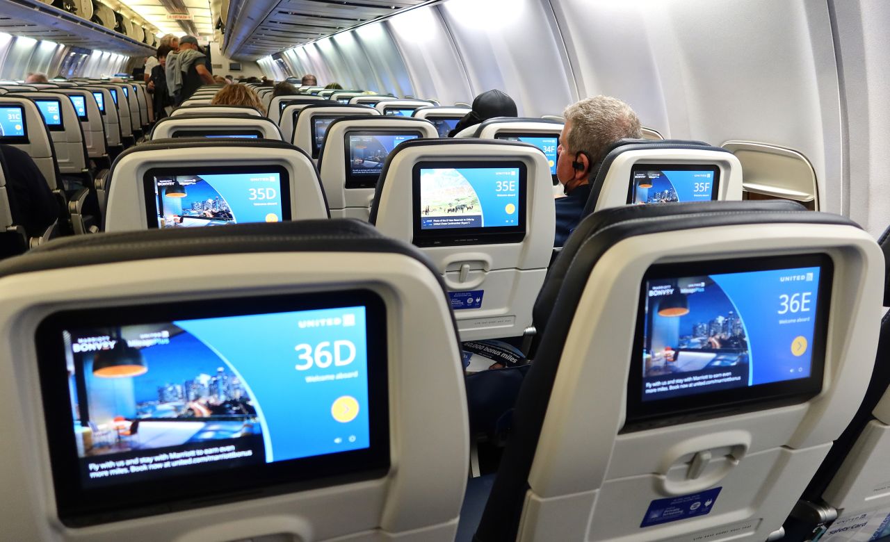 Passengers board a United Airlines plane at Palm Beach International Airport on February 15 in Florida.