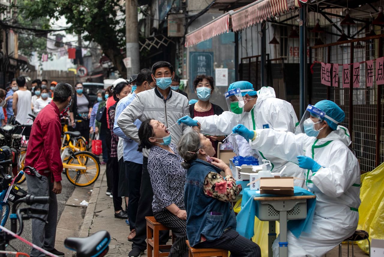 Medical workers take swab samples from residents to be tested for coronavirus on May 15 in Wuhan, China.