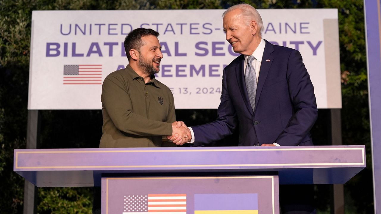 President Joe Biden and Ukrainian President Volodymyr Zelenskyy shake hands after signing a security agreement on the sidelines of the G7, Thursday, June 13,.