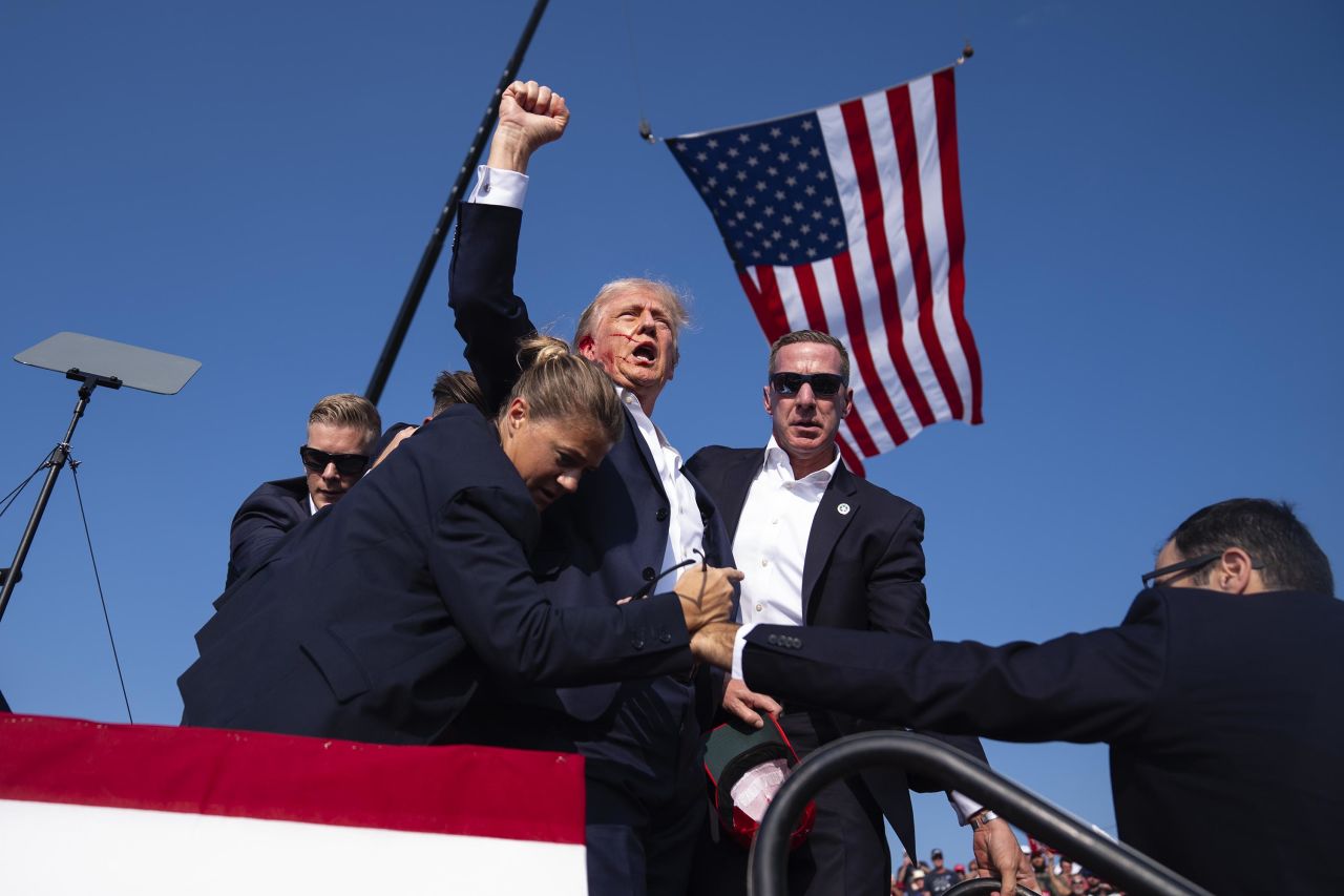 Former President Donald Trump is surrounded by US Secret Service agents at a campaign rally in Butler, Pennsylvania, on Saturday, July 13. 