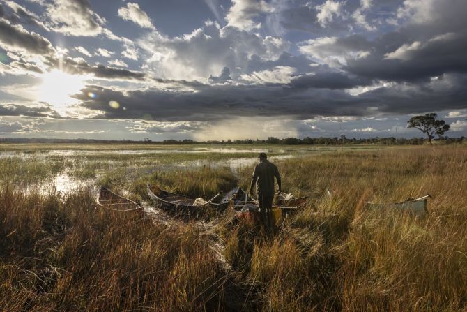 Team member George Matomola unpacks the last of the canoes as a late evening rain sweeps across the floodplains. This year Zambia experienced its <a href="https://www.unocha.org/publications/report/zambia/zambia-drought-response-appeal-may-2024-december-2024-may-2024" target="_blank">driest January and February in more than 40 years</a>, destroying crops and severely affecting power generation.