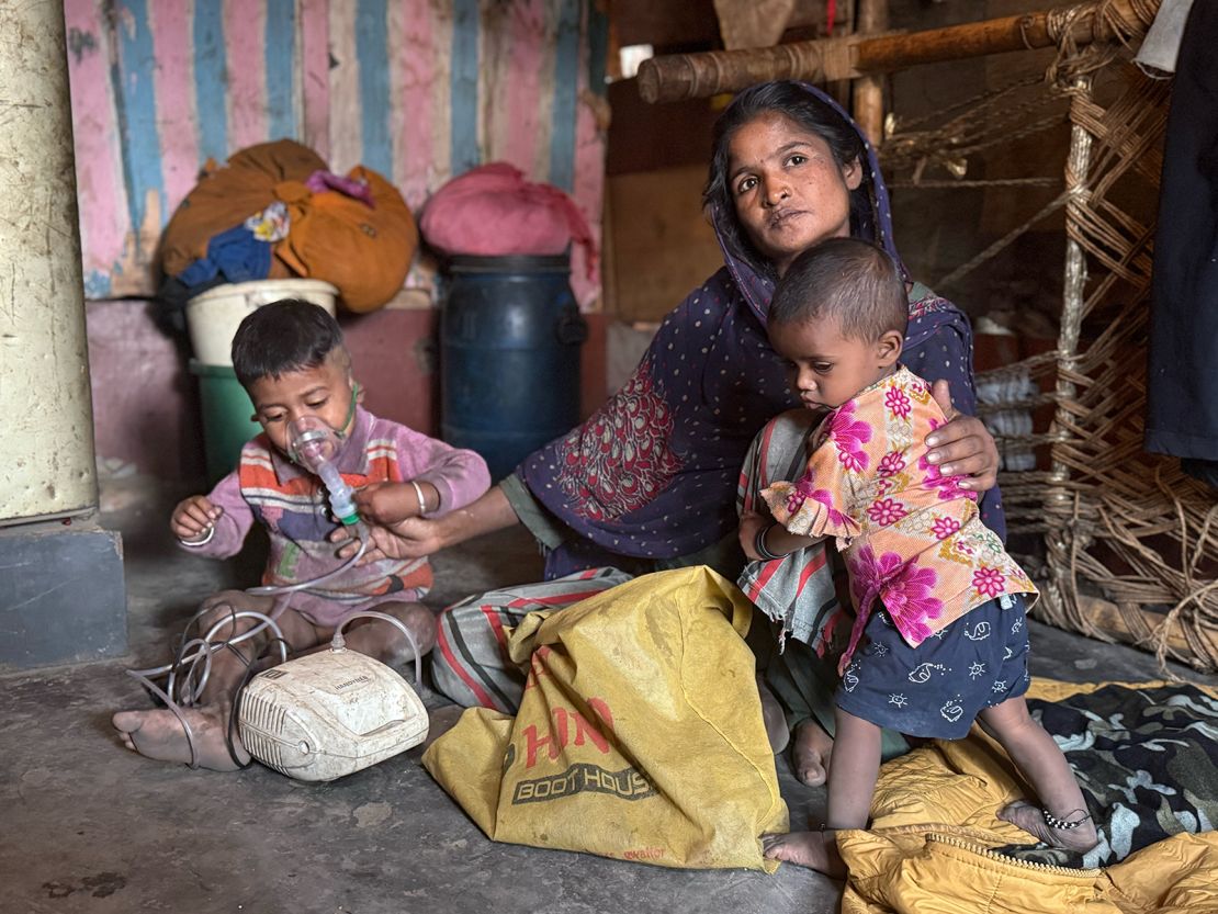 Muskan holds her daughter Diya while while her 3-year-old son Chahat uses the nebulizer. “He thinks it is a toy,” she said as he puts it on himself with ease.