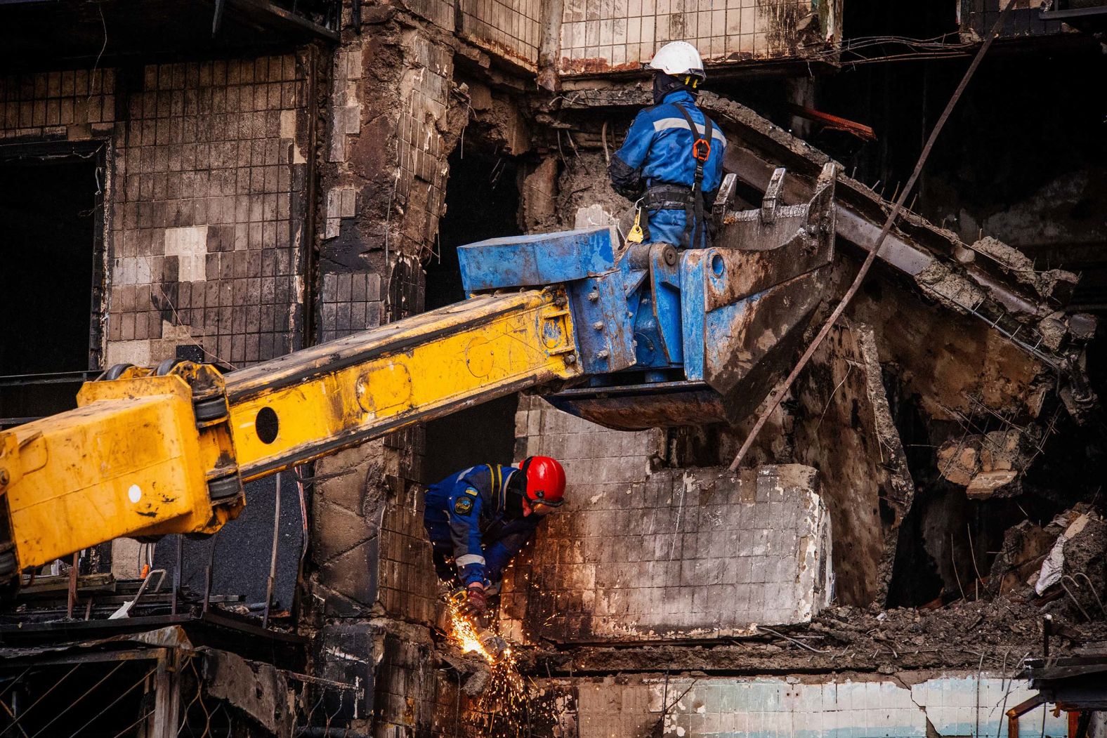 Firefighters work at a destroyed apartment building after a Russian drone attack in Kyiv, Ukraine, on Sunday, October 26.