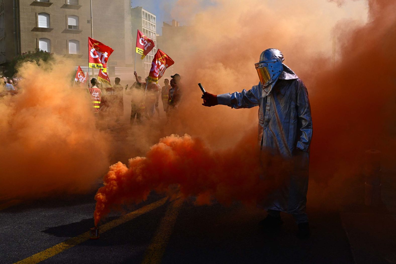 A protester lights flares in Marseille, France, on Thursday, September 18. Hundreds of thousands of people took part in anti-austerity protests across France, unions said, urging President Emmanuel Macron and his new Prime Minister Sebastien Lecornu to acknowledge their anger and scrap looming budget cuts.