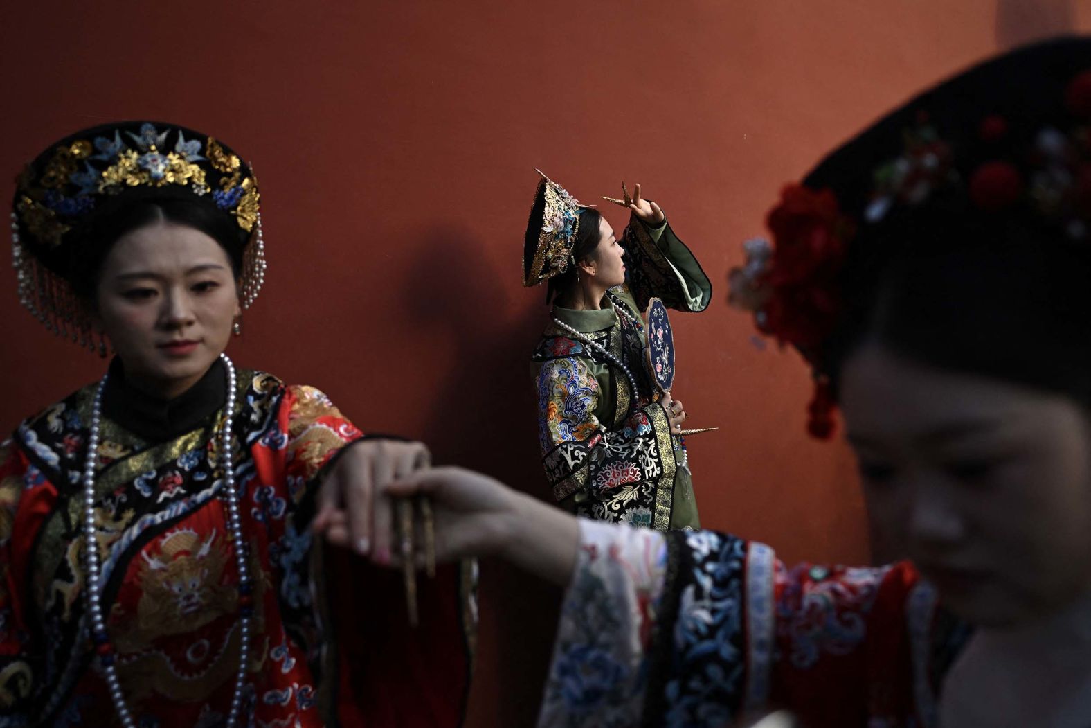 Women wearing traditional Chinese costumes pose for photos as they visit the surroundings of the Forbidden City in Beijing on Monday, October 6. It was during the National Day Golden Week holiday.