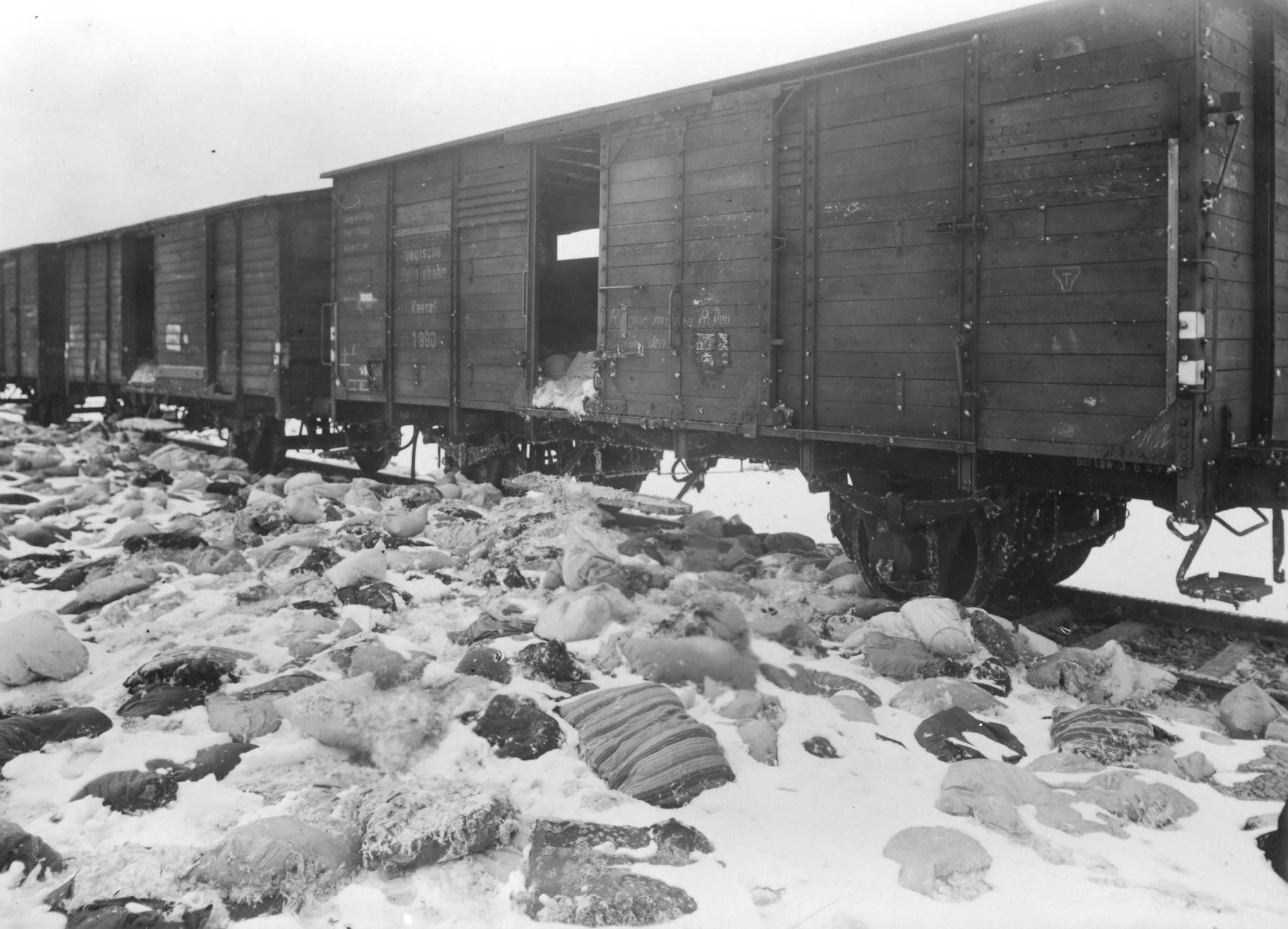 This train was loaded with the personal effects of Auschwitz victims. It was abandoned before it could make its trip to Germany. Some of the freight is scattered and buried in the snow.