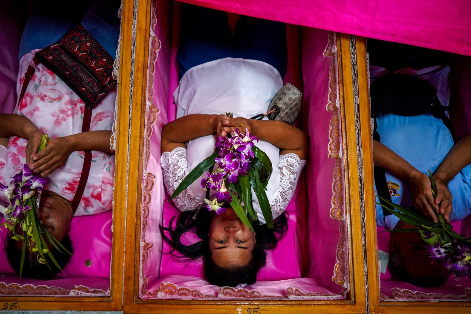 People pray inside coffins at a temple in Nonthaburi, Thailand, on Wednesday, January 1. The ritual is to get rid of bad luck and be reborn for a fresh start in the new year.