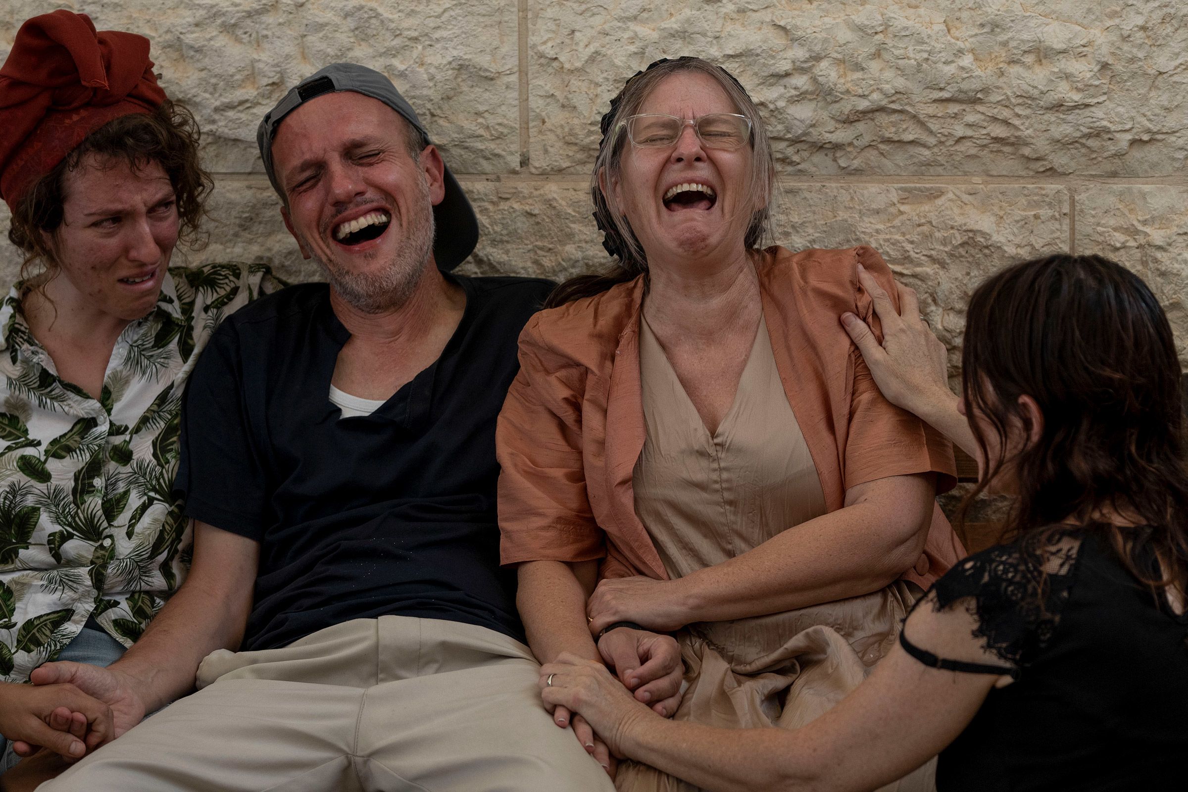 People mourn during their son’s funeral at a cemetery in Modiin Maccabim, Israel, on October 10.