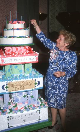 Westheimer reaches for the top of the cake at a surprise birthday party in New York in 1993.