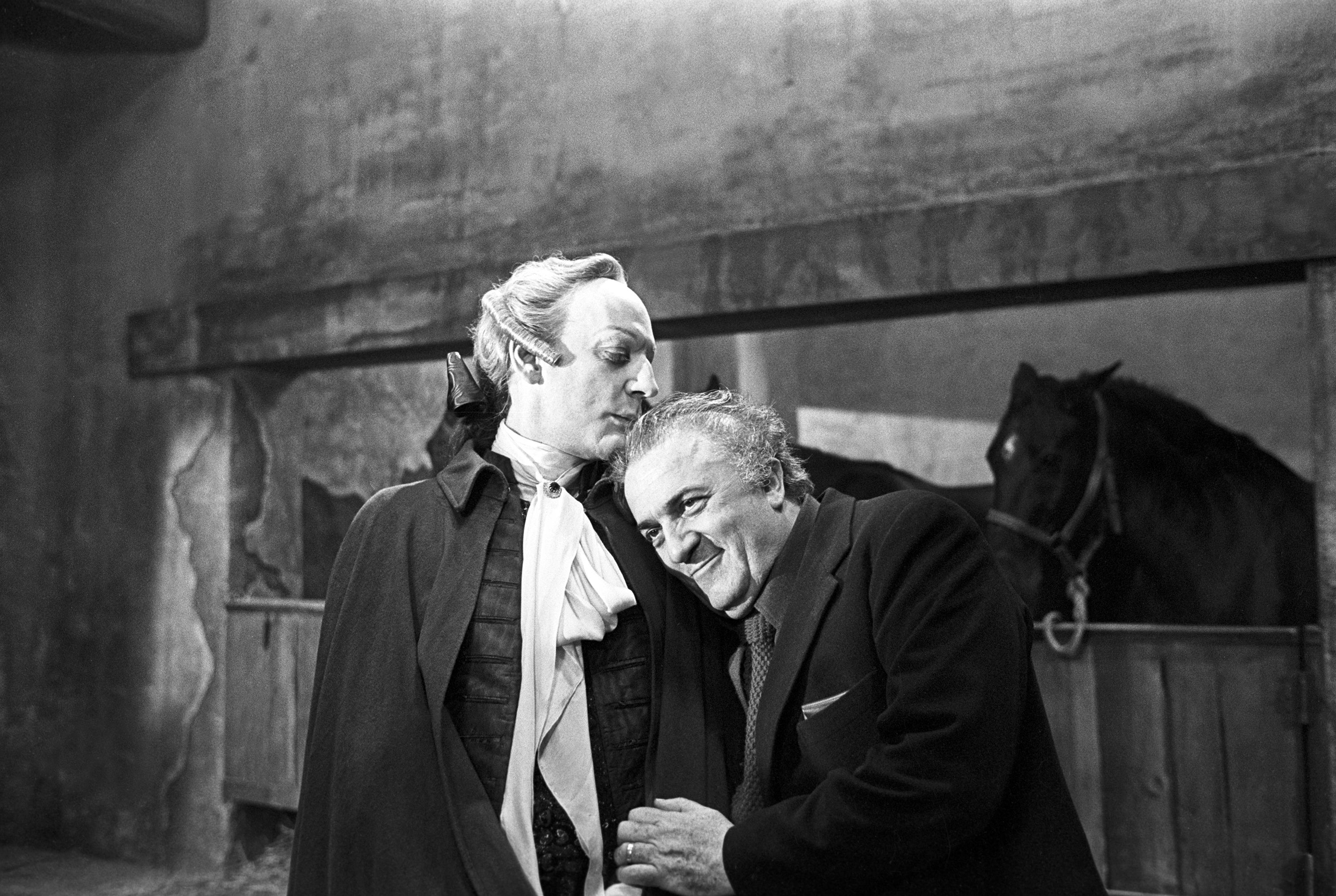 Director Federico Fellini embraces Sutherland on the set of 