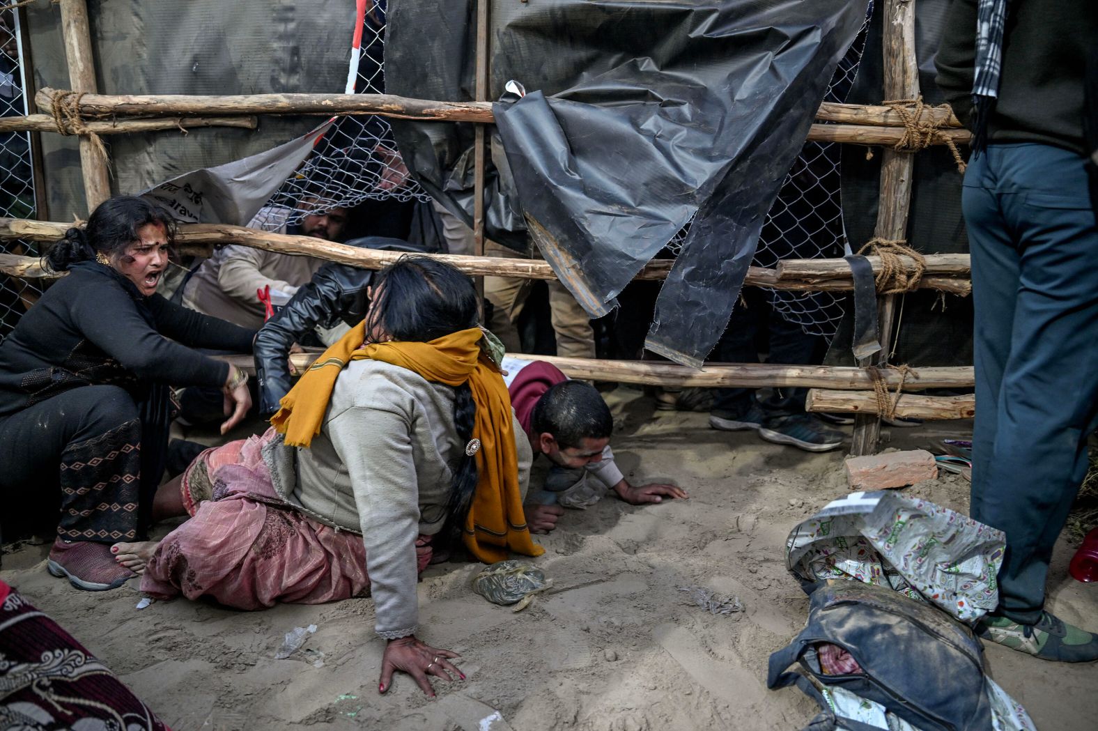 People cross barriers near an area where <a href="index.php?page=&url=https%3A%2F%2Fwww.cnn.com%2F2025%2F01%2F28%2Findia%2Fcrowd-crush-kumbh-mela-india-intl-latam-hnk%2Findex.html">dozens of people were killed in a crowd crush</a> in Prayagraj, India, on Wednesday, January 29. The tragedy happened as tens of millions of Hindu devotees went to bathe in a river on one of the most sacred days of <a href="index.php?page=&url=https%3A%2F%2Fwww.cnn.com%2F2025%2F01%2F12%2Ftravel%2Findia-maha-kumbh-mela-2025-intl-hnk%2Findex.html">Maha Kumbh Mela</a>, or the festival of the Sacred Pitcher.