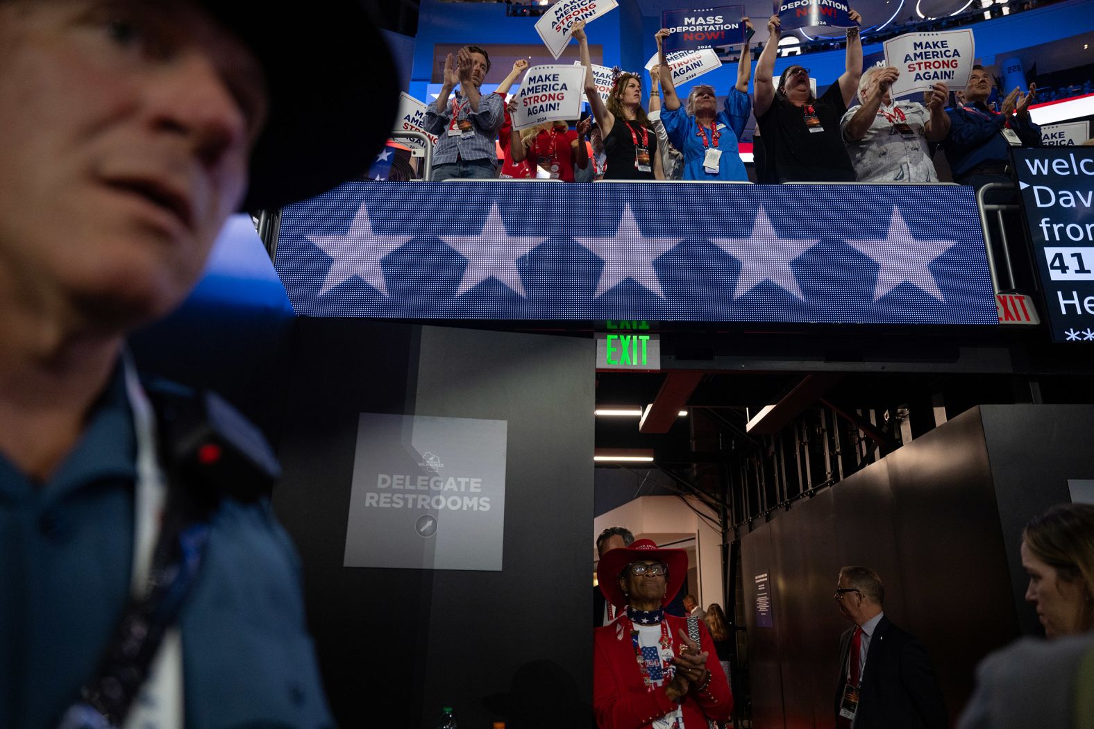 Delegates and alternate delegates wave signs on Wednesday.