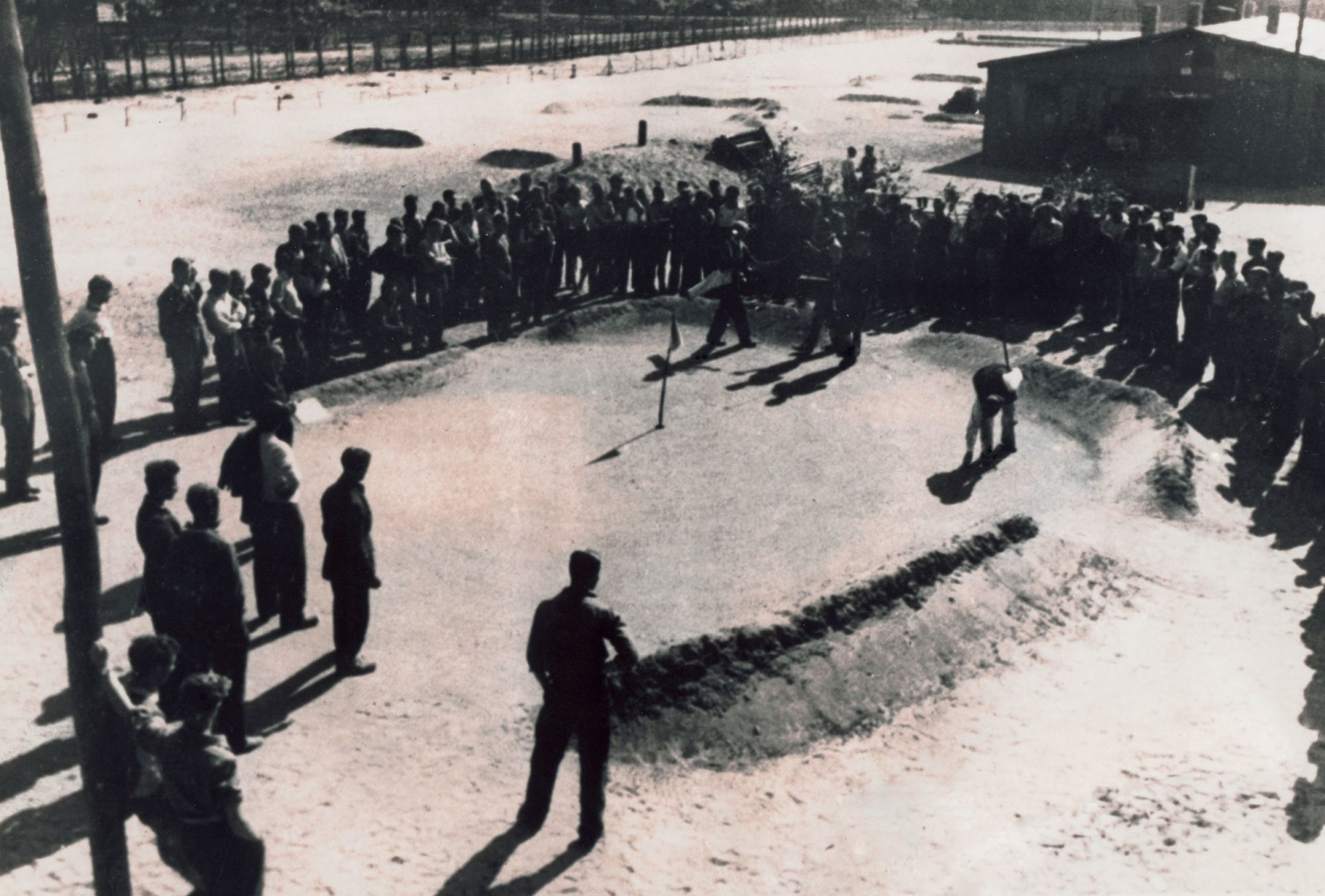 Prisoners of War play golf at Stalag Luft III, a camp run by the German Luftwaffe for captured airmen during the Second World War until its liberation in April 1945.