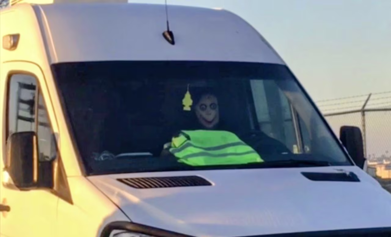 An immigration agent wears a mask resembling a figure associated with the "Momo Challenge" hoax during operations ahead of Halloween.