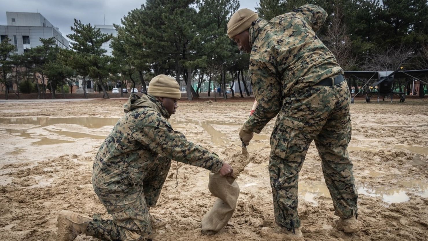 US Marine Corps Cpl. Jamyrion V. Stewart, left, and Sgt. Frederick B. Osei fill sandbags while building a combined command post in preparation for Freedom Shield 24 in Pohang, South Korea, Feb. 25, 2024.