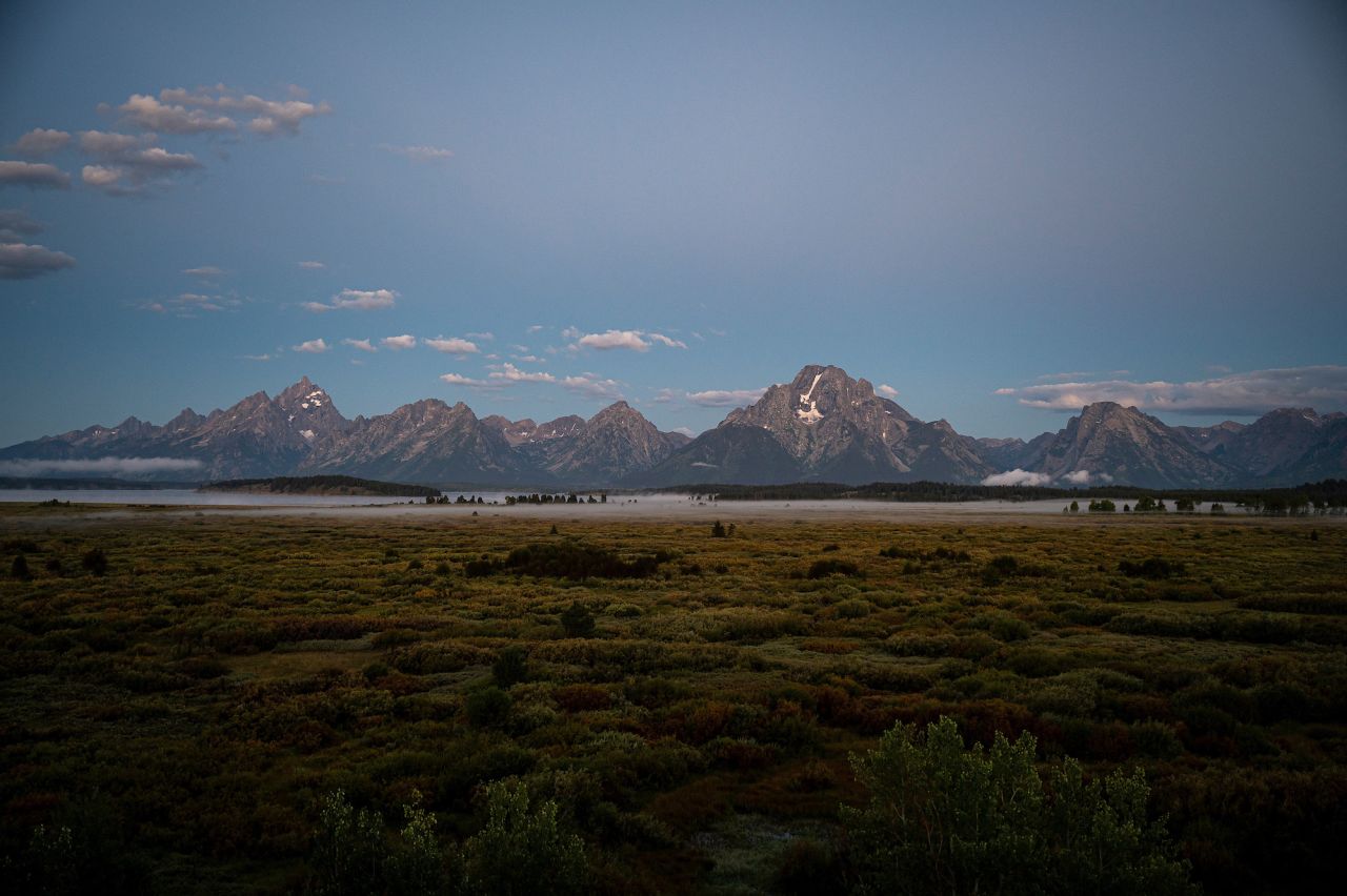 The Grand Tetons are seen at sunrise at the Jackson Hole economic symposium in Moran, Wyoming, on Thursday.