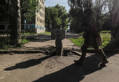 A Ukrainian soldier walks past a part of a rocket near the front line in the city of Severodonetsk, Ukraine on June 2.