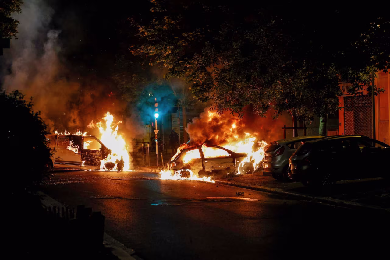 Cars are seen burning in Nanterre on Wednesday.