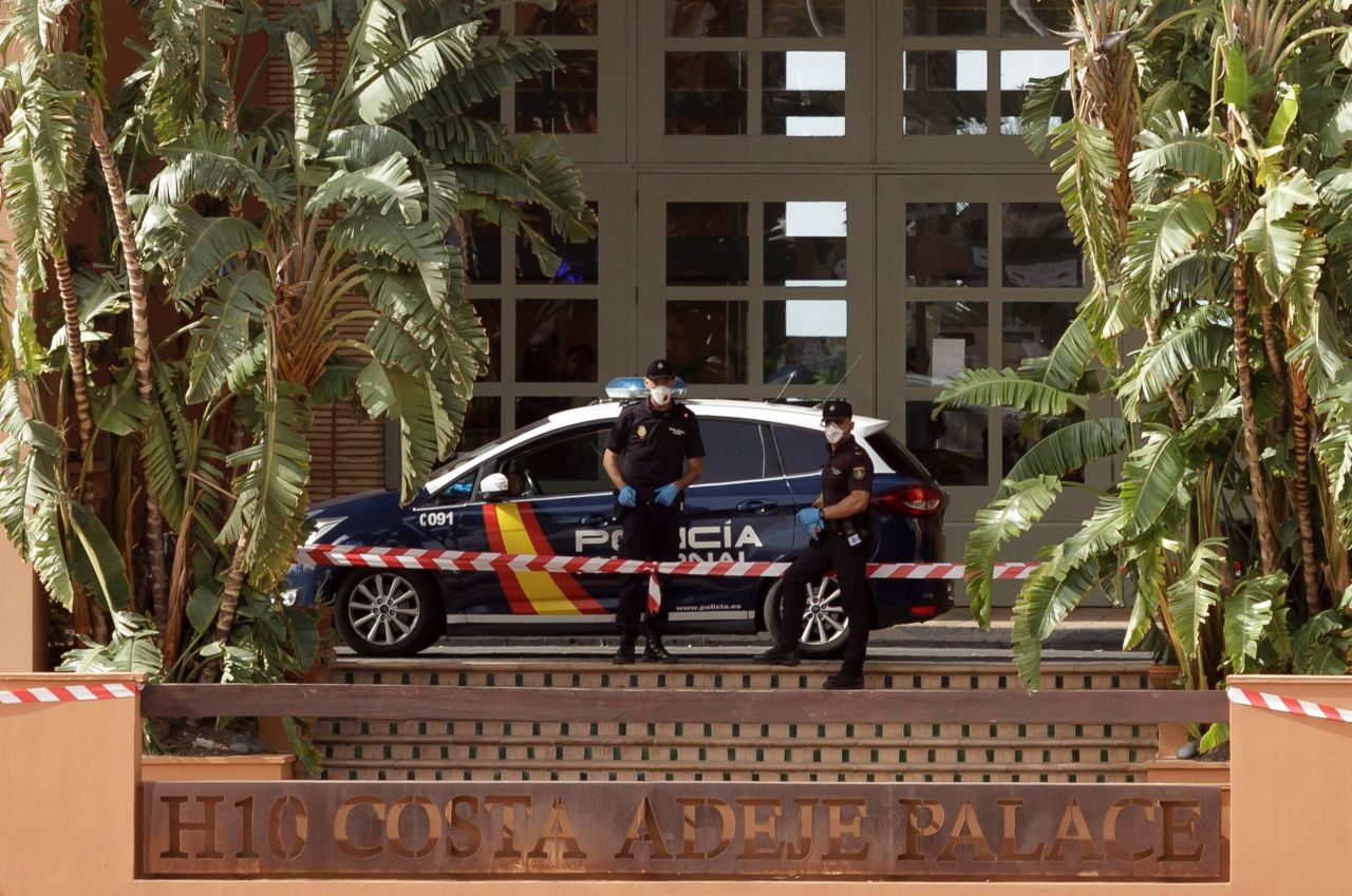 Policemen stand guard outside a hotel in Tenerife that was placed on lockdown after a guest tested positive for Coronavirus on February 25.