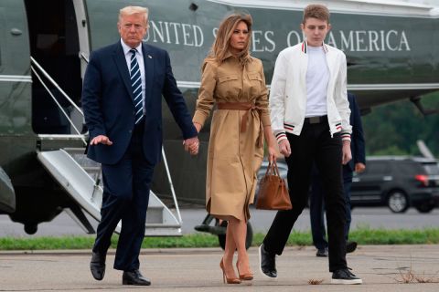 In this August 16 file photo, President Donald Trump walks with First Lady Melania Trump and their son Barron as they arrive at Morristown Municipal Airport in Morristown, New Jersey.