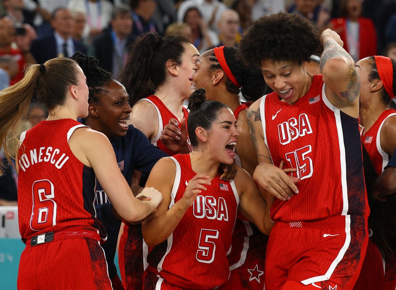 The US basketball team celebrates after defeating France on August 11.