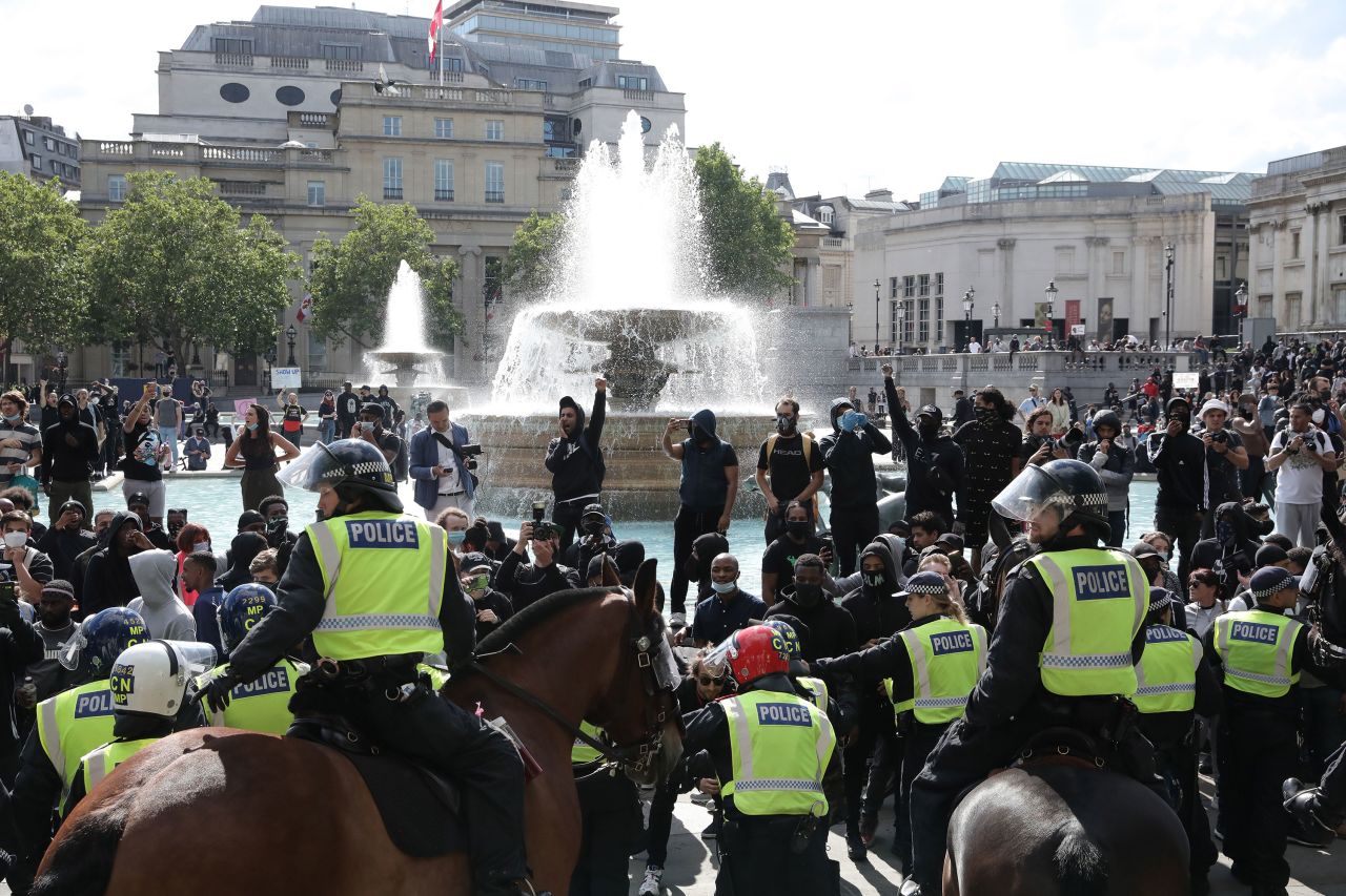 Police monitor protesters in London, England, on June 13.