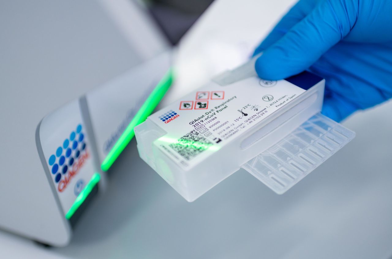 An employee of German biotech company Qiagen demonstrates the use of the Qiagen QIAstat-Dx testing device for infectious diseases at the Qiagen plant on March 11, in Hilden, Germany. Qiagen has modified the device for testing fluid samples for coronavirus infection.