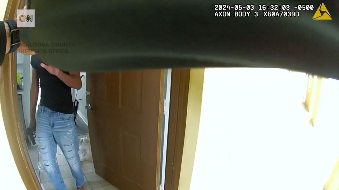 This still image from Deputy Eddie Duran's body camera shows Roger Fortson inside his apartment with his gun pointed down.