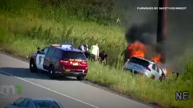 Officer and bystanders rush to pull passenger from burning car