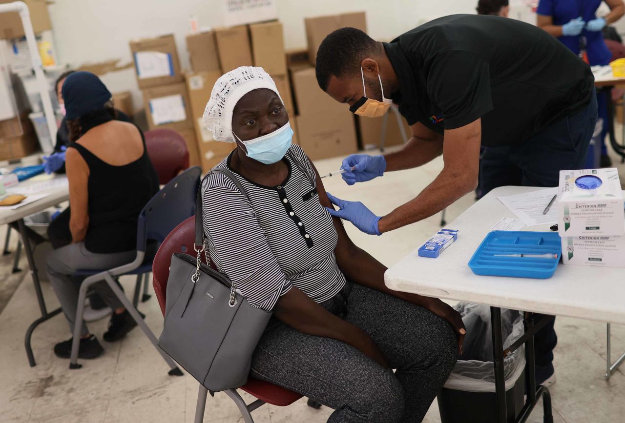 Medical Assistant Odilest Guerrier administers a Moderna COVID-19 vaccine to Marie Val at a clinic in Immokalee, Florida, on May 20. 