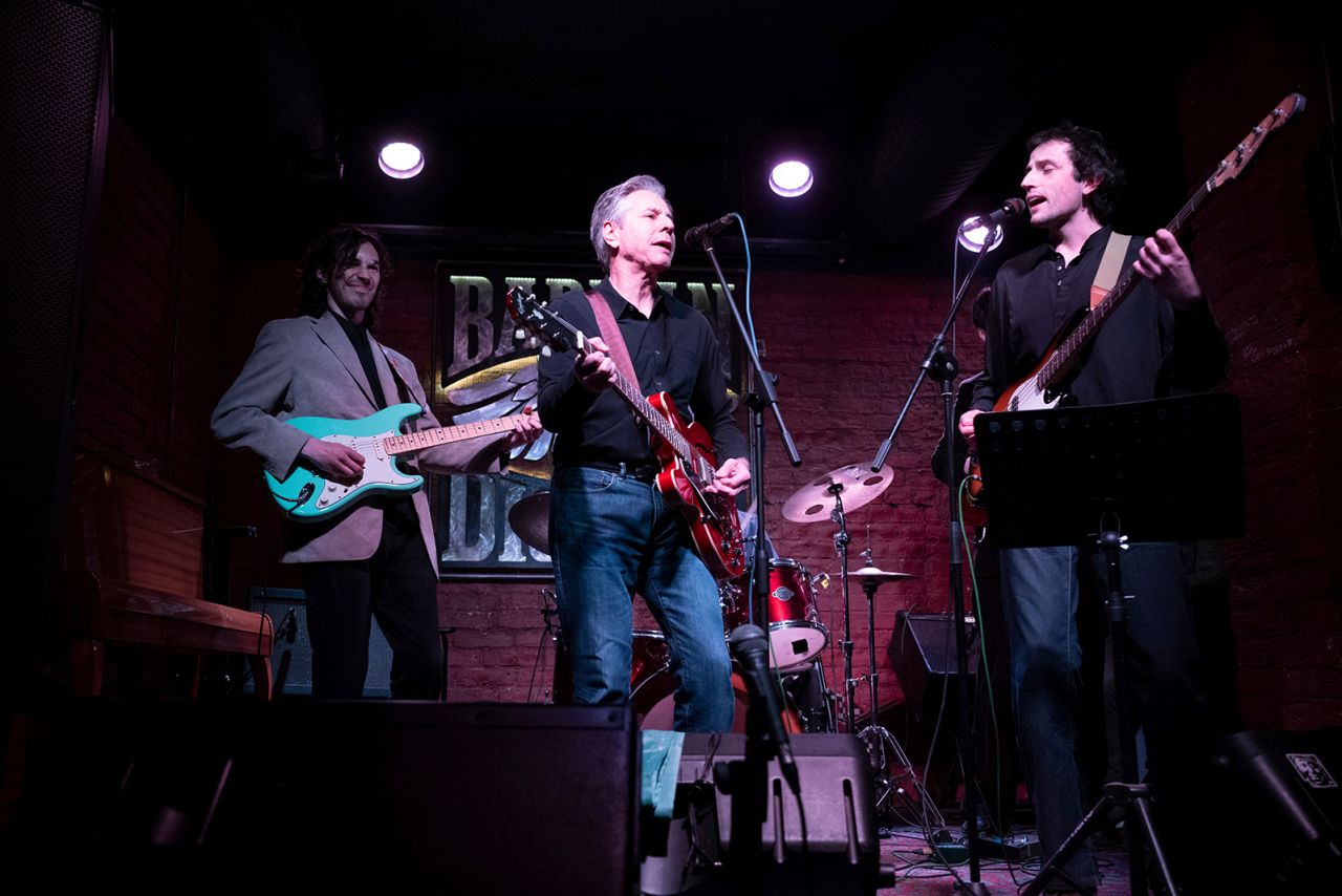 US Secretary of State Antony Blinken performs "Rockin' in the Free World" with members of The 1999 band at the Barman Dictat bar in Kyiv, on May 14.