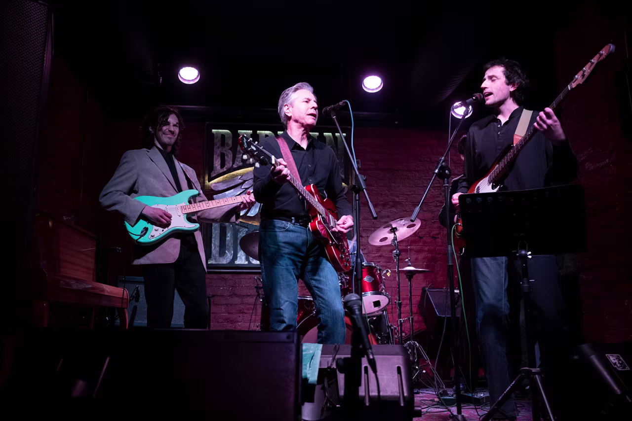 US Secretary of State Antony Blinken performs "Rockin' in the Free World" with members of The 1999 band at the Barman Dictat bar in Kyiv, on May 14.