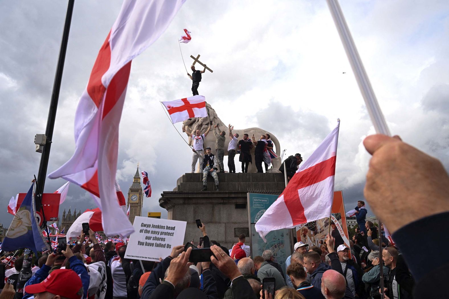 Protesters climb a statue by Westminster Bridge on the day of an <a href="index.php?page=&url=https%3A%2F%2Fwww.cnn.com%2F2025%2F09%2F13%2Feurope%2Ffar-right-anti-immigration-protests-london-intl">anti-immigration rally in London</a> on Saturday, September 13. The Unite the Kingdom protest was organized by far-right political activist Tommy Robinson. Counter-protesters also flocked to the British capital.