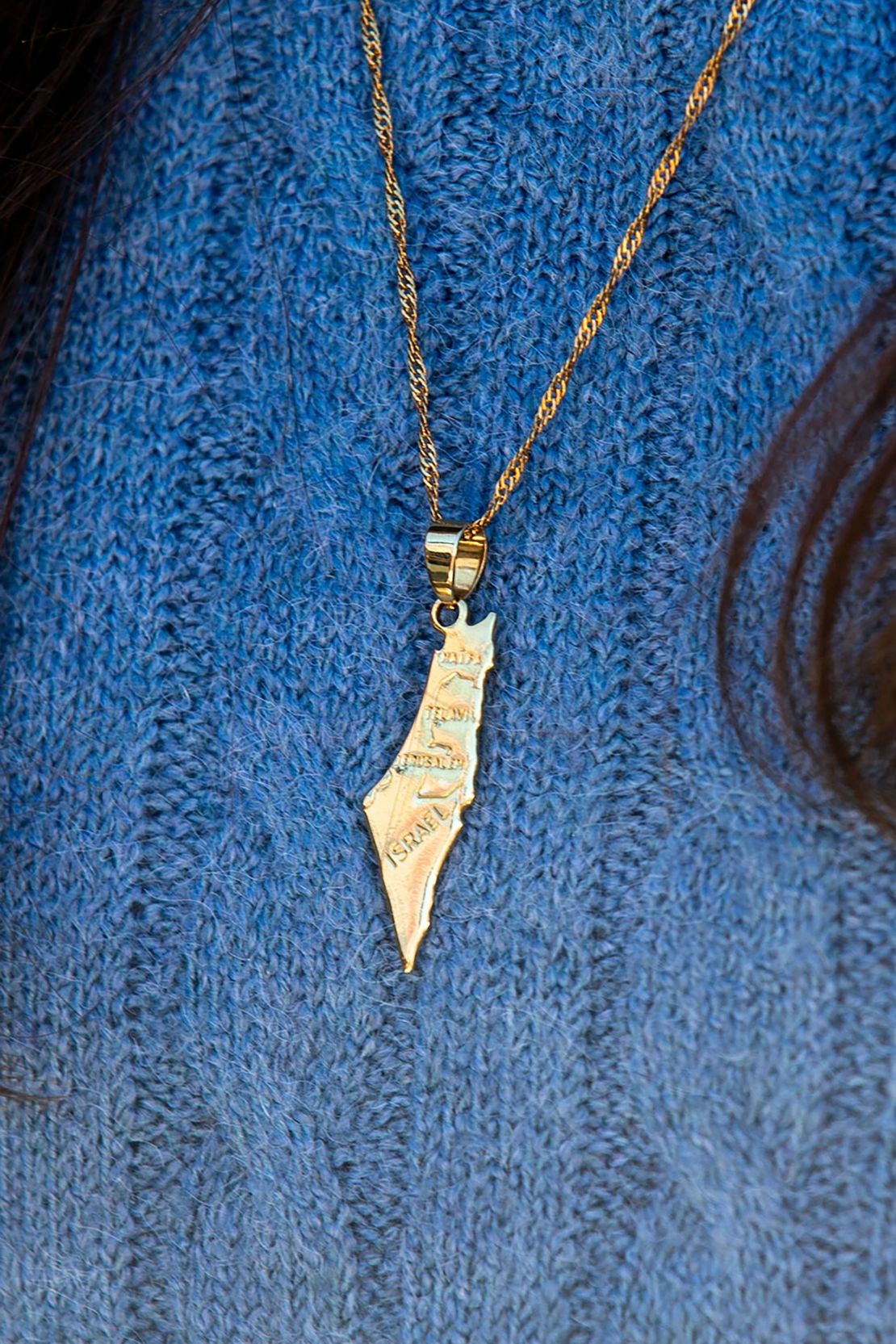 A young woman wears a necklace showing Israel and the occupied Palestinian territories during Tuesday's pro-Israel demonstration.