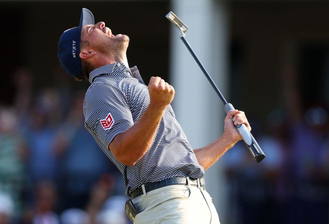 Bryson DeChambeau reacts on the 18th green after he made a putt to <a href=