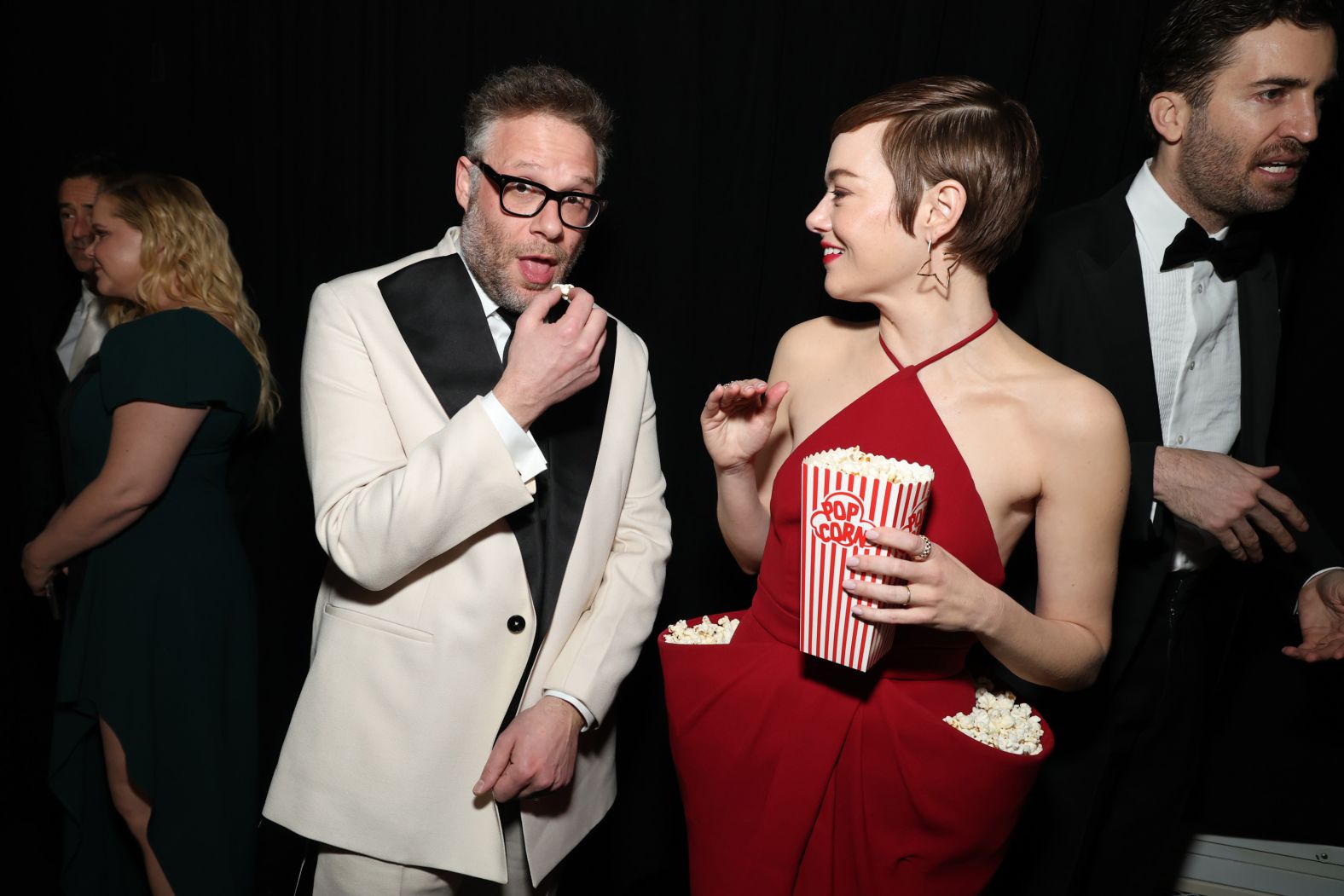 Actor Seth Rogen snacks on Emma Stone’s popcorn as they attend the 50th anniversary celebration of “Saturday Night Live” on Sunday, February 16. <a href="https://www.cnn.com/2025/02/17/style/emma-stone-popcorn-dress-pocket/index.html">Stone’s floor-length scarlet gown</a> was a custom Louis Vuitton creation, though it was unclear whether the luxury house designed the deep pockets with the movie snack in mind.