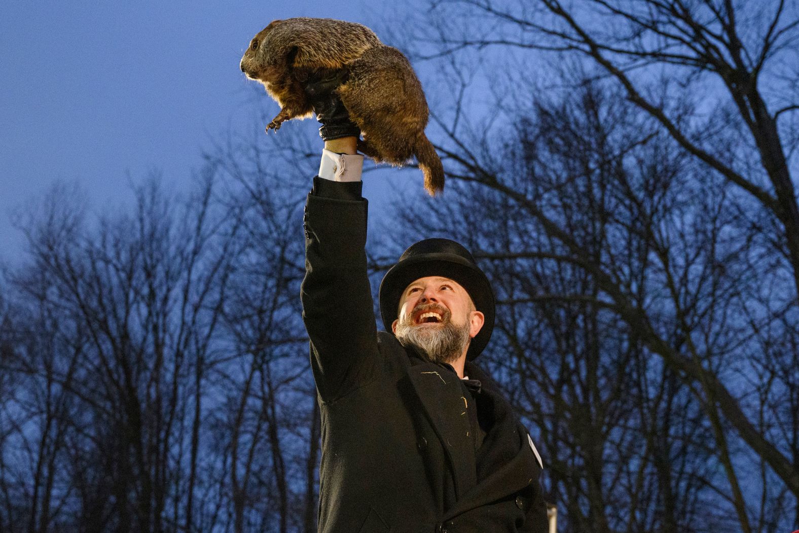 Groundhog handler AJ Dereume holds up Punxsutawney Phil after the famous groundhog <a href="index.php?page=&url=https%3A%2F%2Fwww.cnn.com%2F2024%2F02%2F02%2Fweather%2Fgroundhog-day-winter-spring-climate%2Findex.html">did not see his shadow</a> in Punxsutawney, Pennsylvania, on Friday, February 2. As legend has it, if Phil doesn’t see his shadow, an early spring arrives.