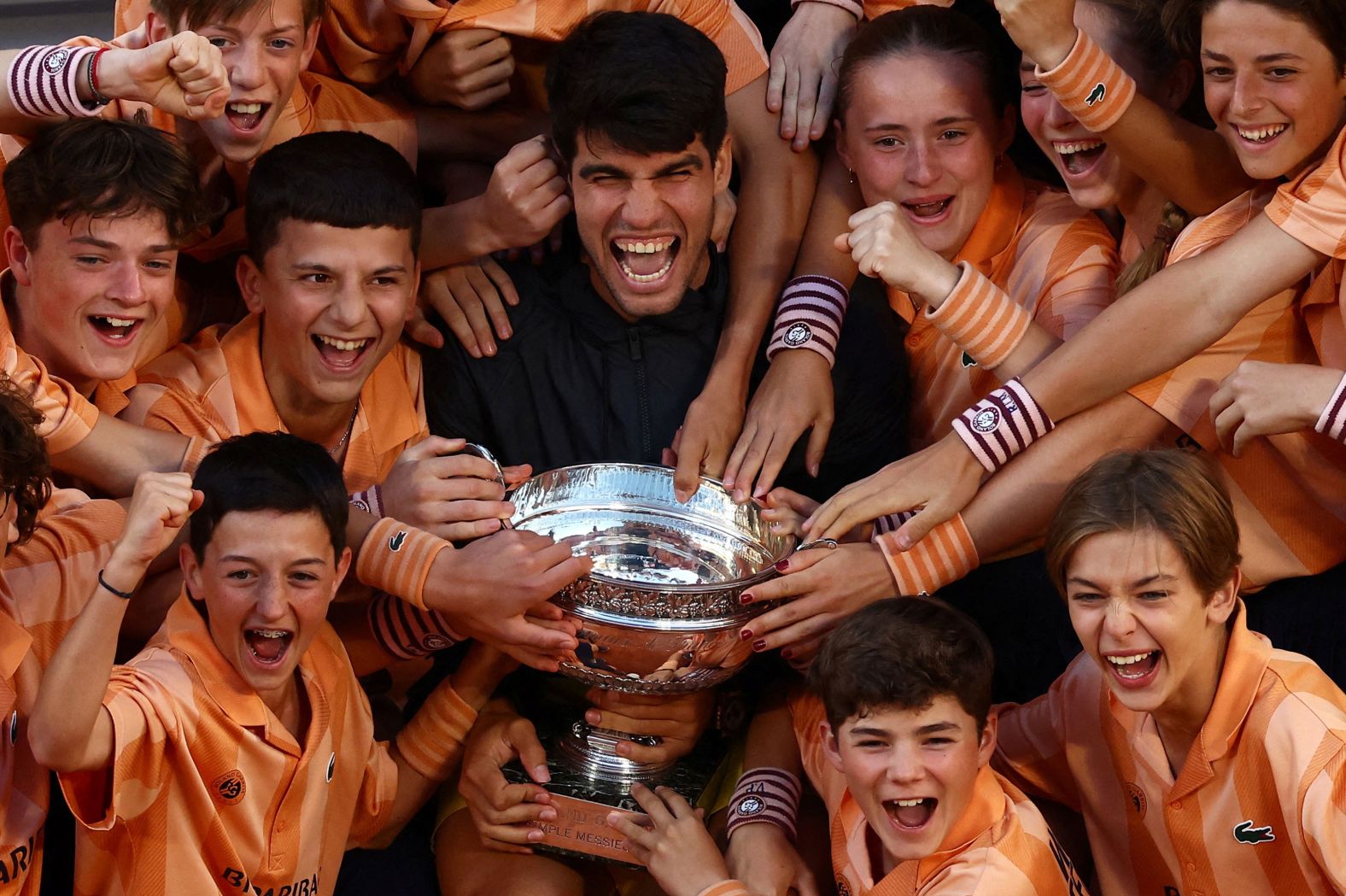 Tennis star Carlos Alcaraz with ball kids after <a href="https://www.cnn.com/2024/06/09/sport/french-open-final-mens-final-2024-spt-intl/index.html">winning the French Open</a> on Sunday, June 9. Alcaraz won his third grand slam title, and his first French Open, by defeating Alexander Zverev in five sets.